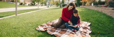 mom and son reading outside