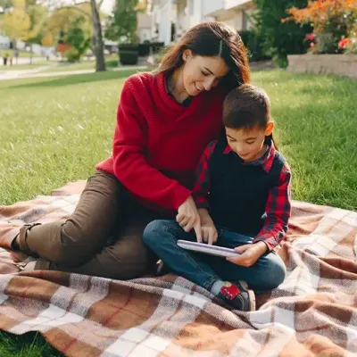 mom and son reading outside